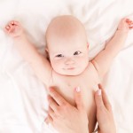Mother massaging baby