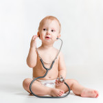 cute baby with stethoscope in hands