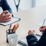 Close up interviewer interview candidate apply for job at meeting room in office.