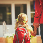 father and little daughter go to school or daycare