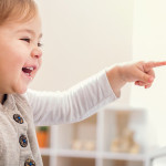 48141649 - happy smiling toddler girl excited to play the piano