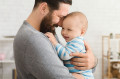 Loving father embracing his cute baby son
