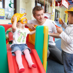 Man with children playing together